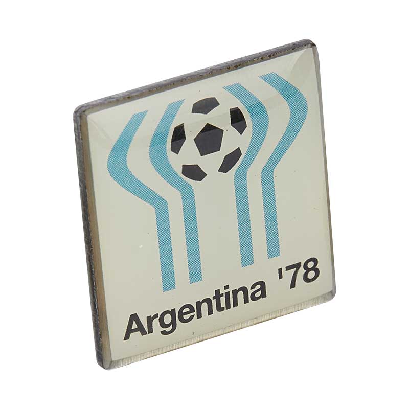 White Square pin with black & blue elements and an illustration of a football at the top, representing the World Cup in Argentina in 1978.
