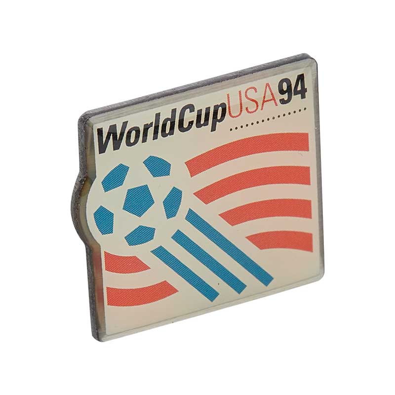 White Square pin with rounded borders with blue, red, and black elements, representing the FIFA World Cup celebration in the USA in 1994.