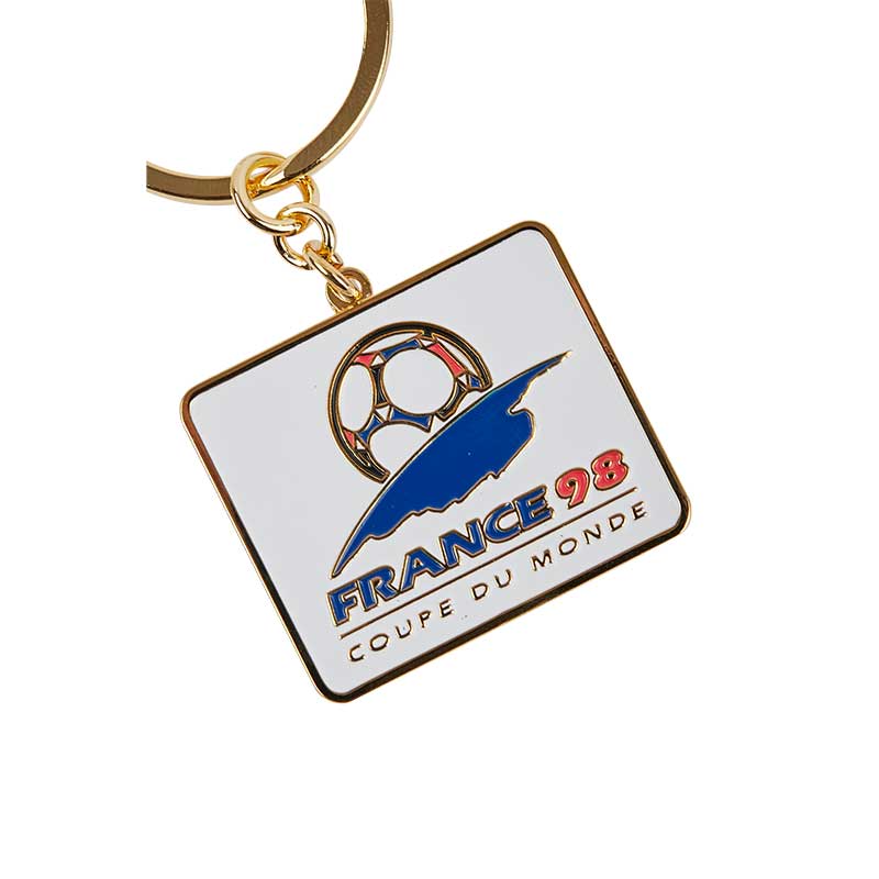 White square keyring with rounded borders with blue and red elements representing the FIFA World Cup tournament in 1998 in France.