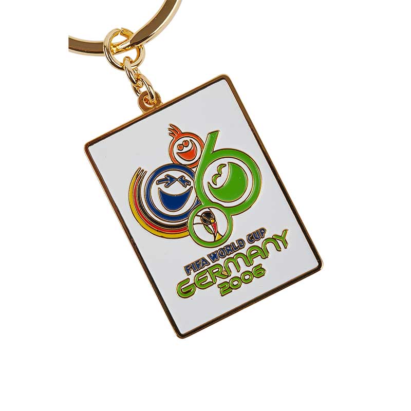 White rectangular keyring with colorful smiley emojis and the German flag, representing the FIFA World Cup celebration in Germany in 2006.